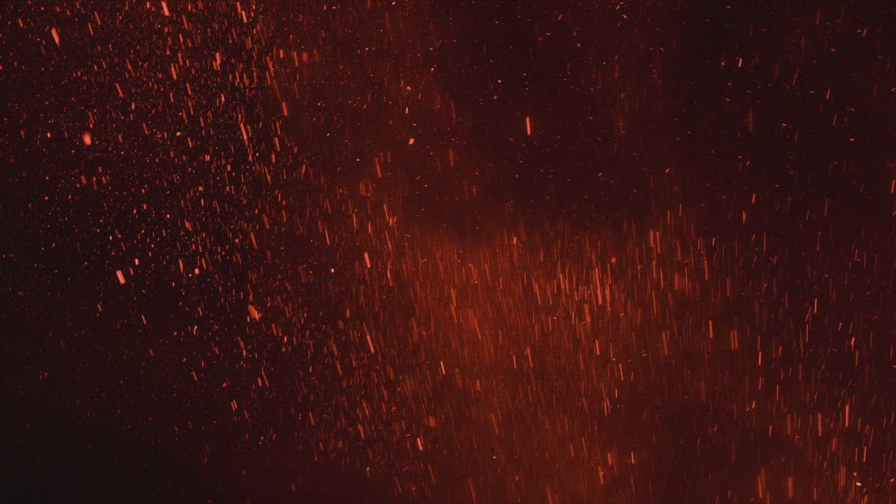 灰烬和燃烧的熔岩粒子在黑暗背景上跃跃在空中发出火热色彩的镜头背景视频模板素材完整版免费下载